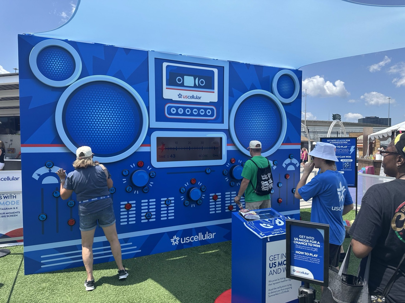 Guests playing the backlit button wall as the score and timer run on the boombox display
