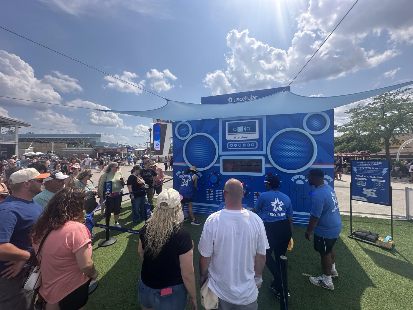 The full US Mode footprint at Summerfest under shade sails with crowd all around